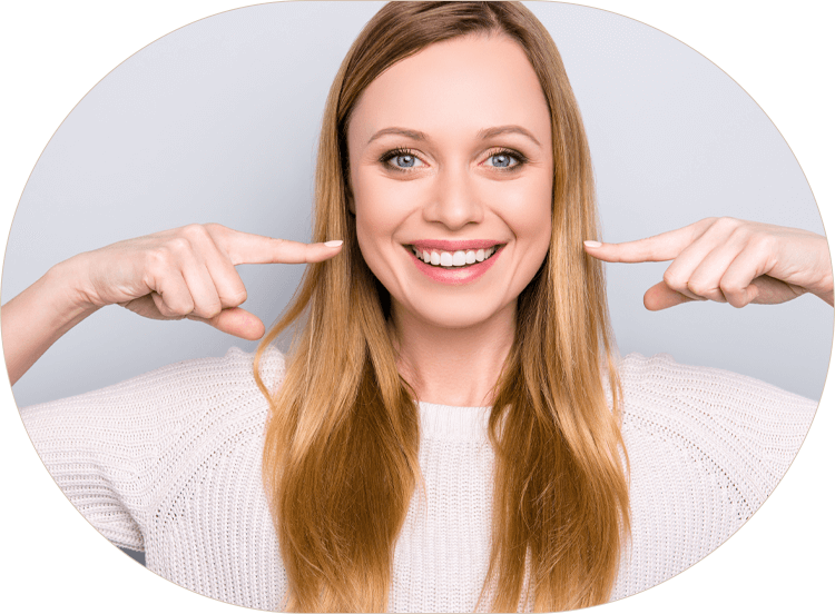 woman pointing to her bright, white smile