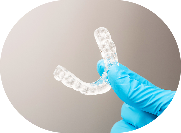 dentist holding an occlusal splint used to reduce nighttime bruxism